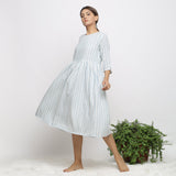 Left View of a Model wearing Off-White Handspun Cotton Muslin Dress