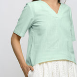 Front Detail of a Model wearing Aqua Yarn Dyed 100% Cotton V-Neck High-Low Top