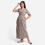 Left View of a Model wearing Ash Grey Dabu Print 100% Cotton Wrap Dress