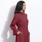 Right View of a Model wearing Barn Red Cotton Waffle Turtle Neck Overalls