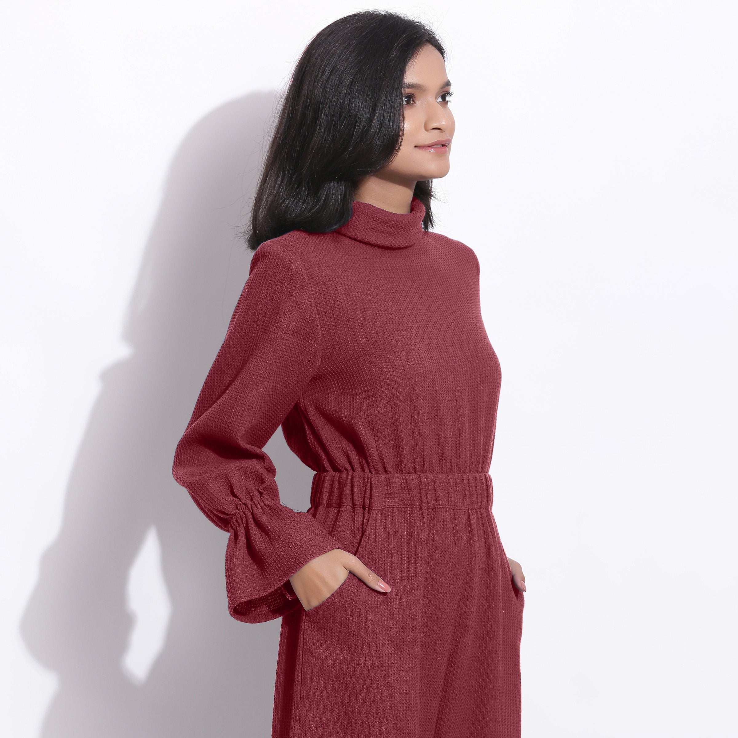 Right View of a Model wearing Barn Red Cotton Waffle Turtle Neck Overalls