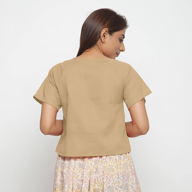 Back View of a Model wearing Beige Boat Neck Half Sleeve Cotton Top