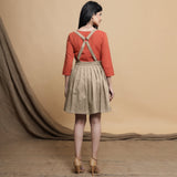 Back View of a Model wearing Beige Pleated Cotton Flax Knee Length Criss-Cross Back Dress