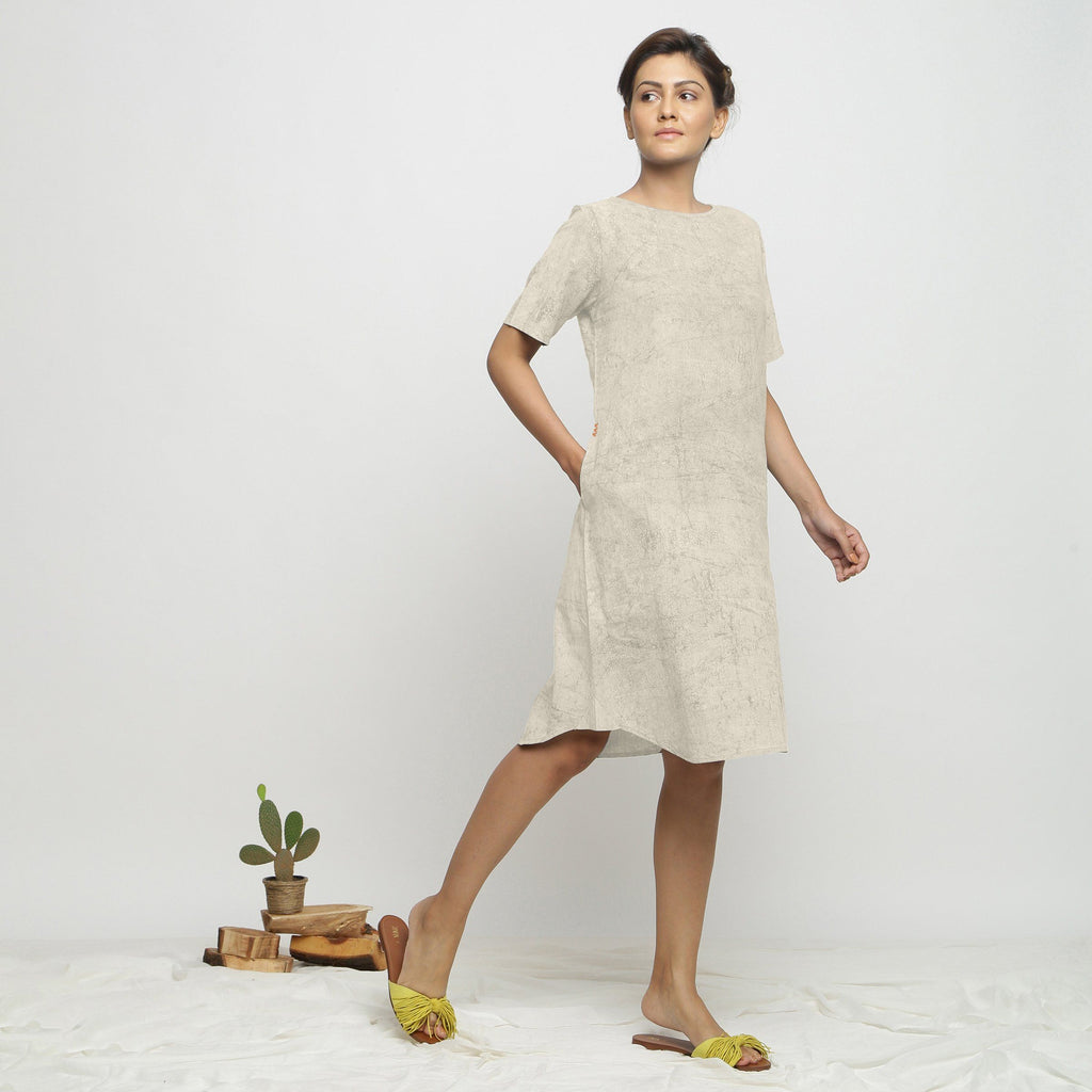 Right View of a Model wearing Beige Dabu Print Hand Embroidered Dress