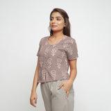 Left View of a Model wearing Beige Dabu Print Relaxed Sleeves Button-Down Top