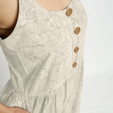Front Detail of a Model wearing Beige Dabu Printed Button-Down Jumpsuit