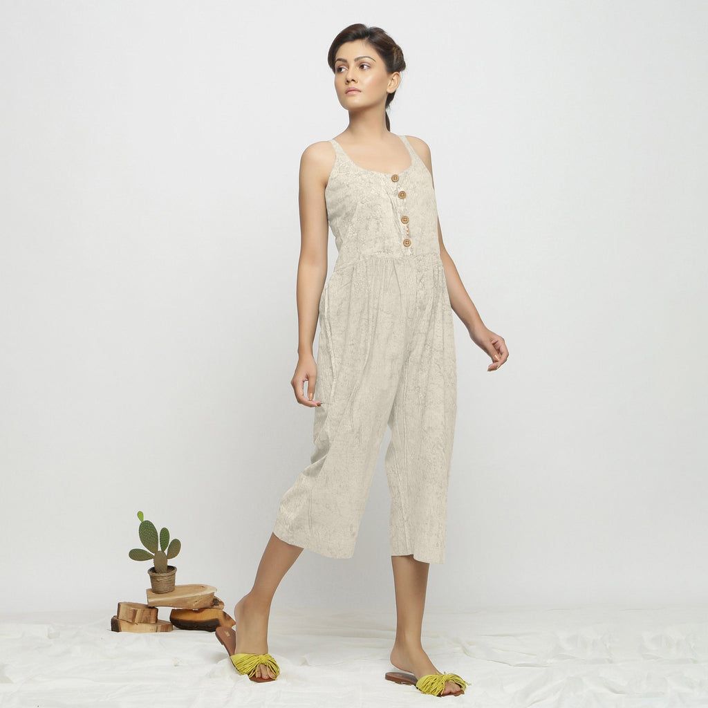 Right View of a Model wearing Beige Dabu Printed Button-Down Jumpsuit