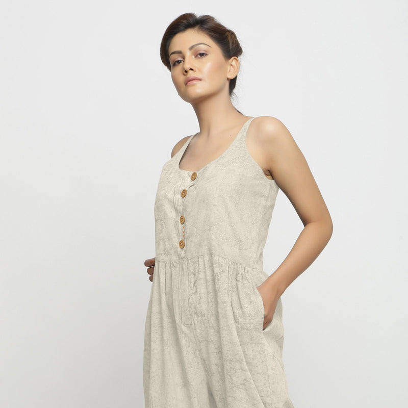 Left View of a Model wearing Beige Dabu Printed Button-Down Jumpsuit
