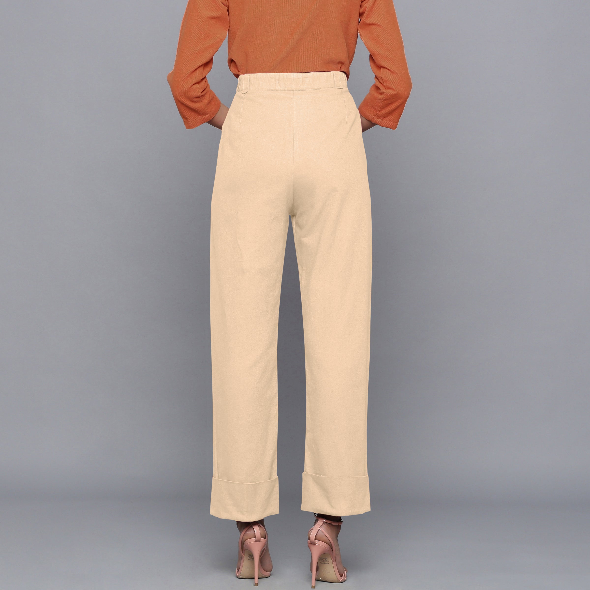 Back View of a Model wearing Beige Flannel Rolled-Up Straight Pant