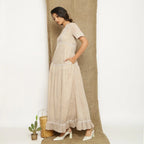 Left View of a Model wearing Handspun Cotton Lace Yoked Dress