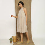 Left View of a Model wearing Handspun Cotton Lace Paneled Dress