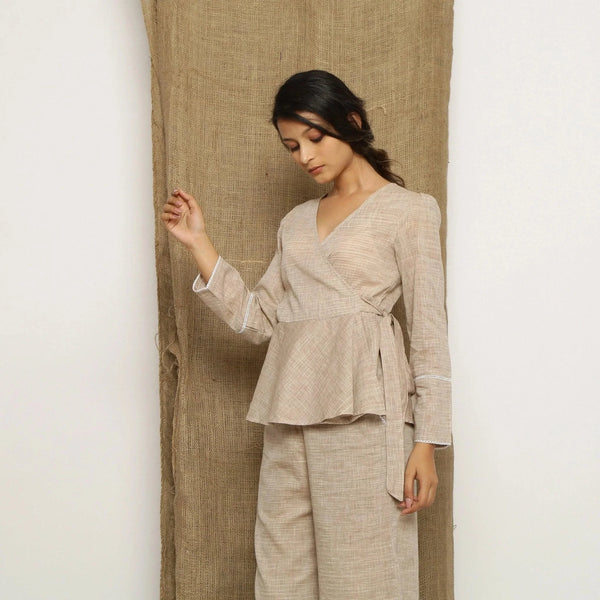 Left View of a Model wearing Beige Handspun Full Sleeve V-Neck Wrap Top