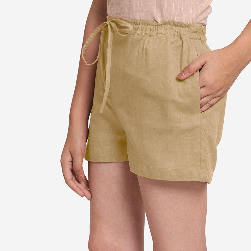 Left View of a Model wearing Beige Mid-Rise Cotton Straight Shorts