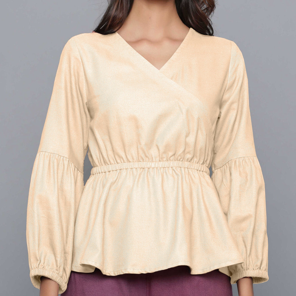 Front Detail of a Model wearing Beige V-Neck Flannel Peplum Top