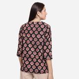 Back View of a Model wearing Black Bagru-Printed Shawl Collar Top