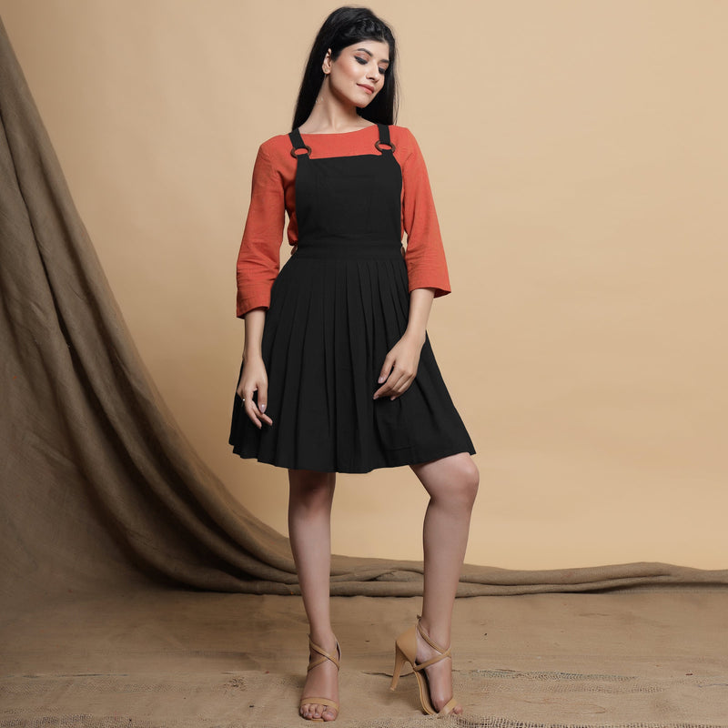 Front View of a Model wearing Black Pleated Cotton Flax Knee Length Criss-Cross Back Dress