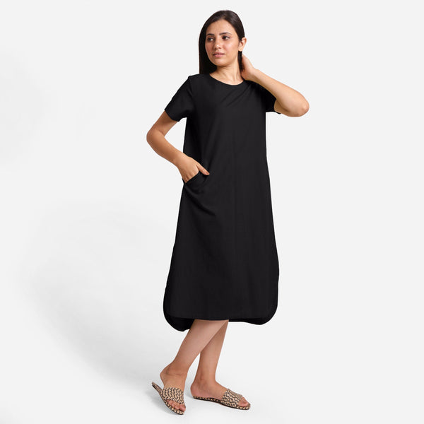 Right View of a Model wearing Black Cotton Welt Pocket Shift Dress