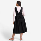 Back View of a Model wearing Black Deep Neck Pinafore Midi Wrap Dress