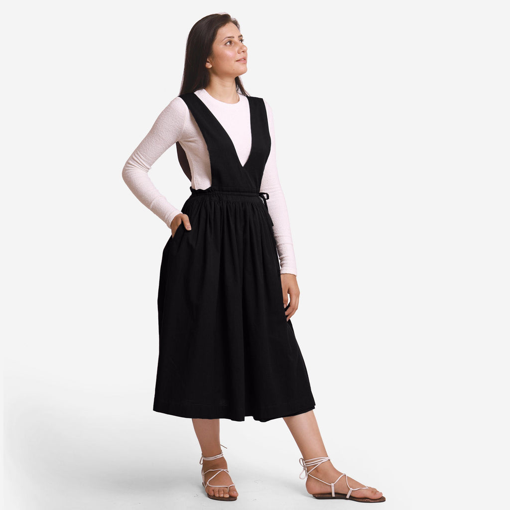 Right View of a Model wearing Black Deep Neck Pinafore Midi Wrap Dress