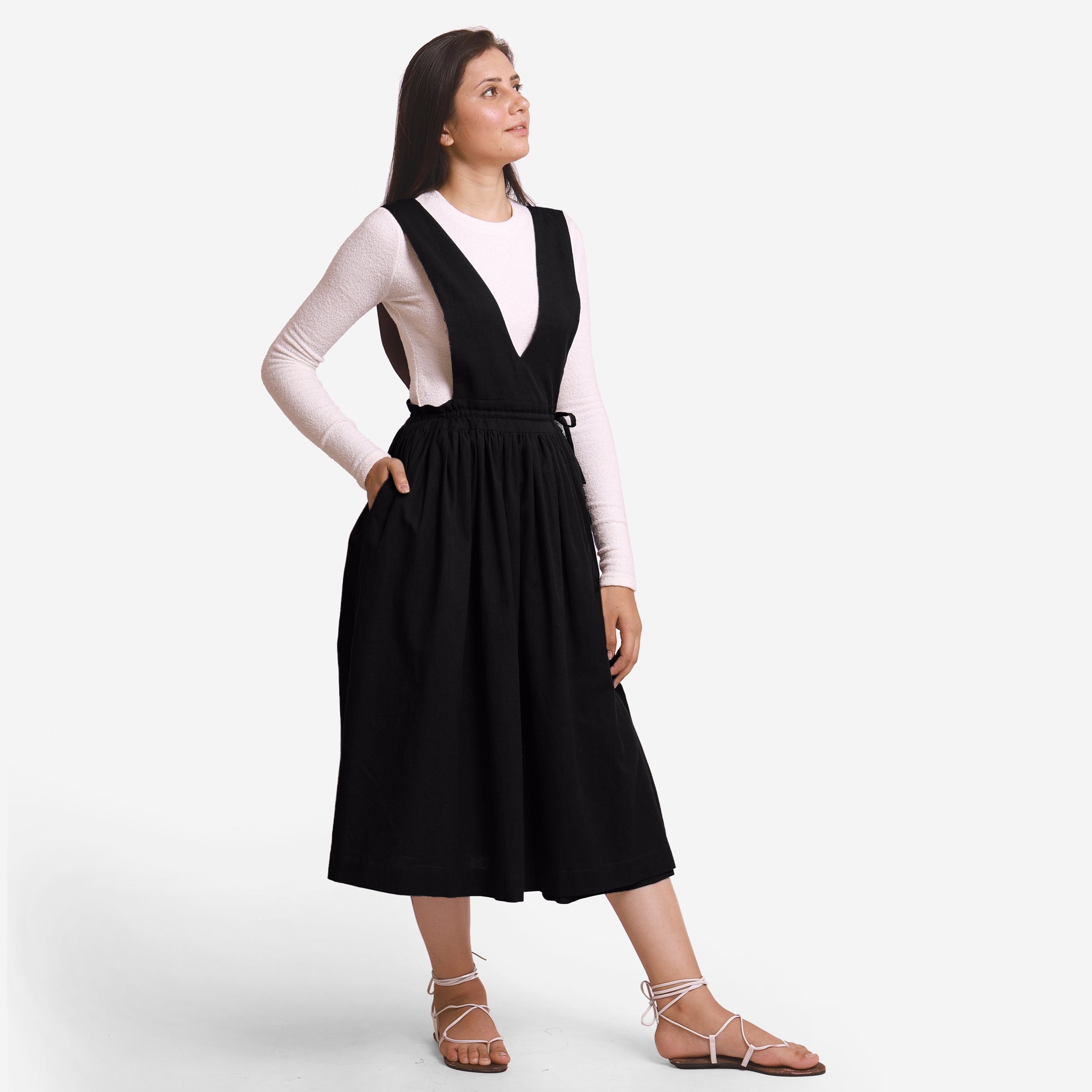 Right View of a Model wearing Black Deep Neck Pinafore Midi Wrap Dress