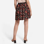 Back View of a Model wearing Black Floral A-Line Cotton Flared Skirt