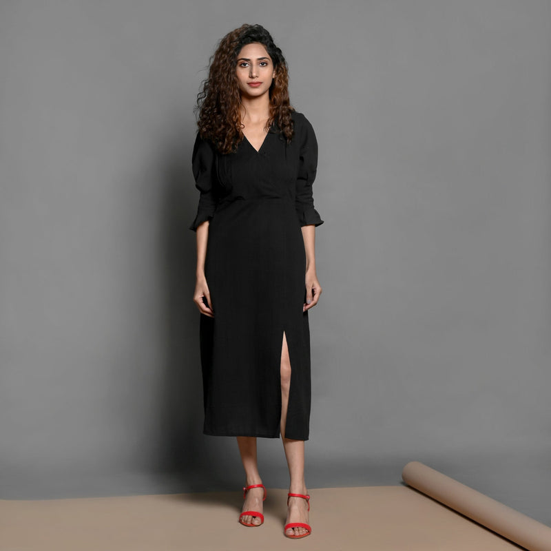 Front View of a Model wearing Black Handspun Cotton Surplice Neck Pleated Midi Dress