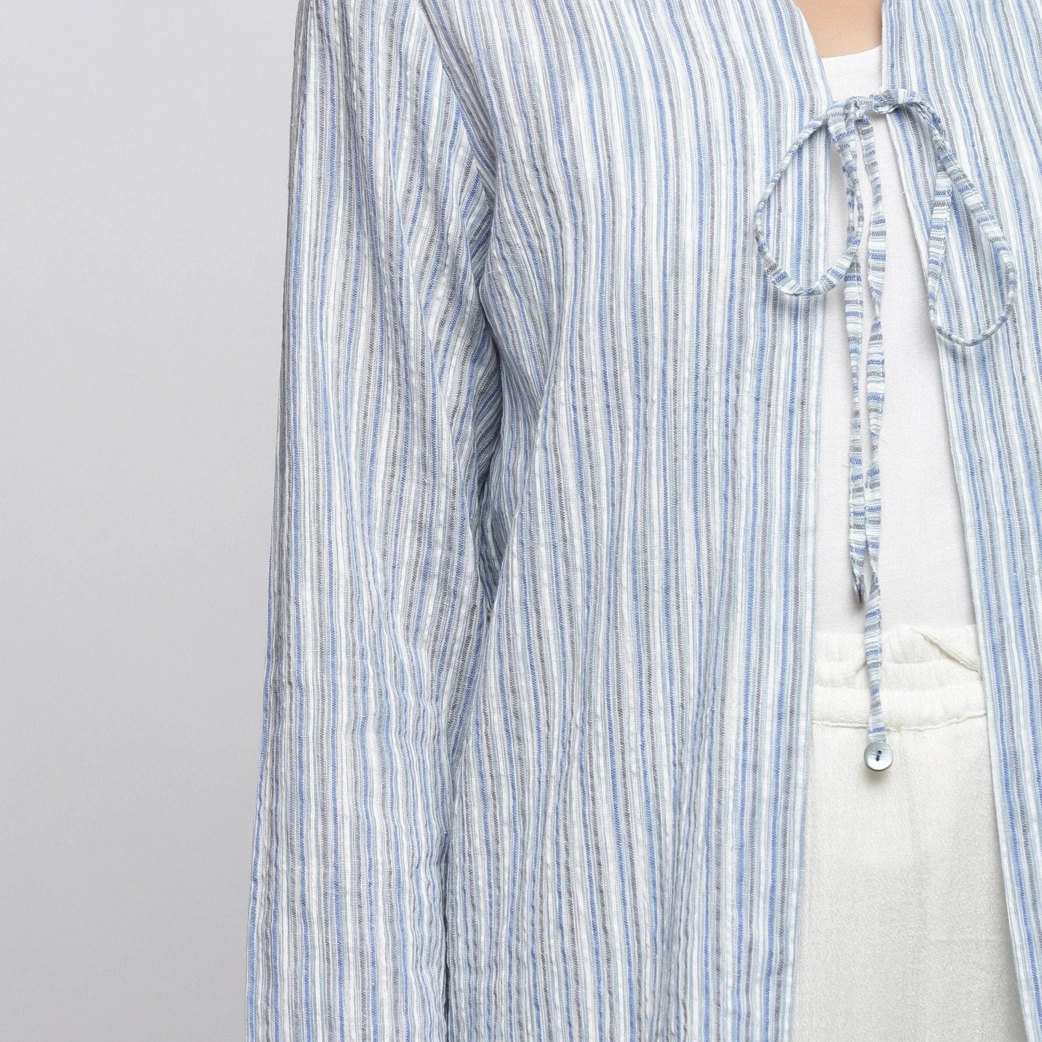 Front Detail of a Model wearing Blue and White Striped V-Neck Shrug