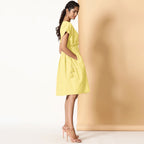 Right View of a Model wearing Lemon Yellow Frilled Cotton Knee Length Bohemian Dress