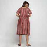 Back View of a Model wearing Brick Red Bagru Asymmetrical Midi Dress