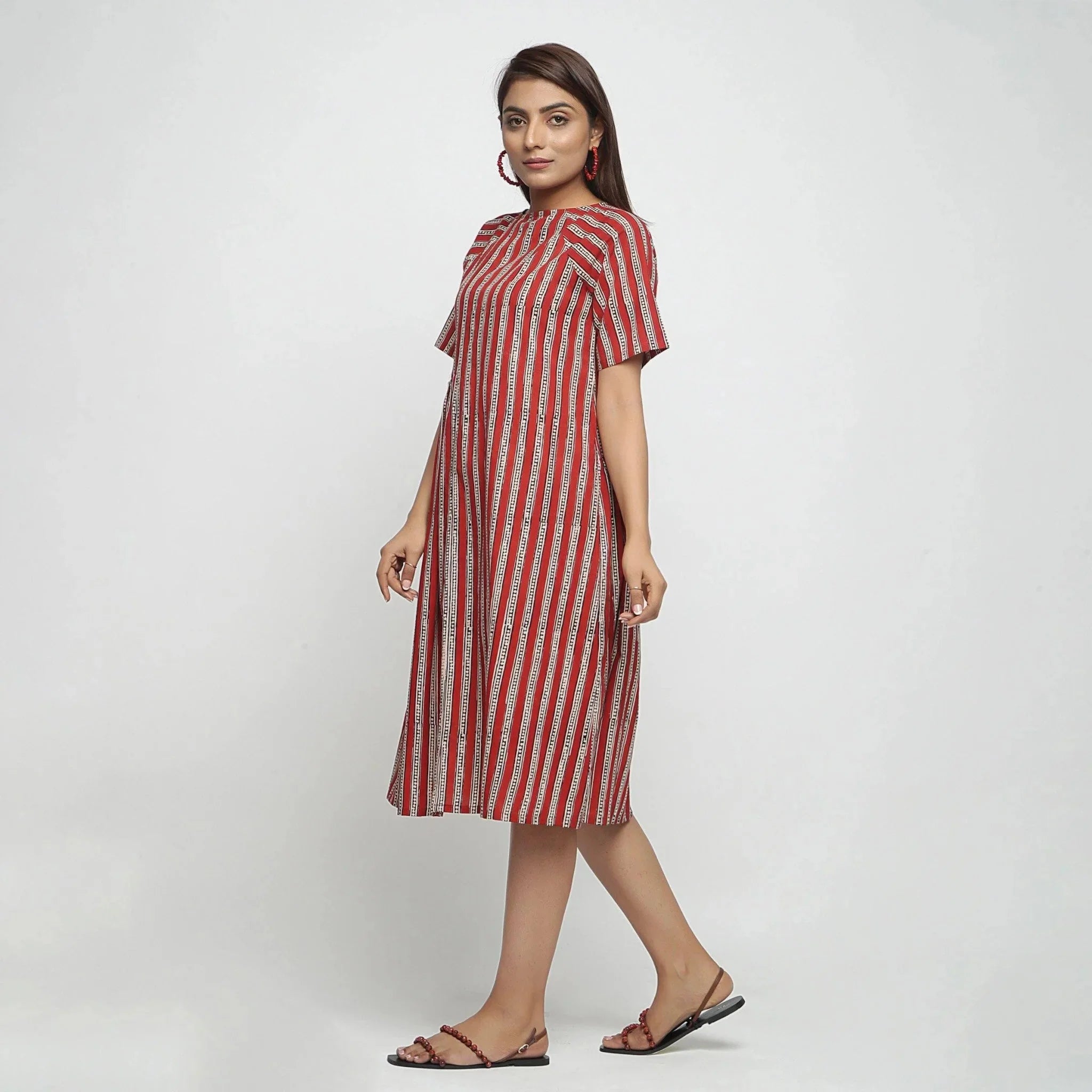 Left View of a Model wearing Brick Red Bagru Asymmetrical Midi Dress
