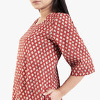 Left Detail of a Model wearing Brick Red Block Printed Cotton Floor Length Bohemian Dress