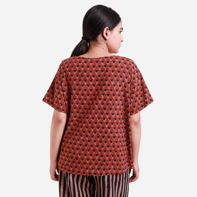 Back View of a Model wearing Brick Red Floral Block Print Straight Top