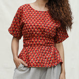 Front Detail of a Model wearing Brick Red Floral Block Printed Cotton Peplum Top