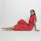 Left View of a Model wearing Brick Red Vegetable Dyed Button-Down Jumpsuit