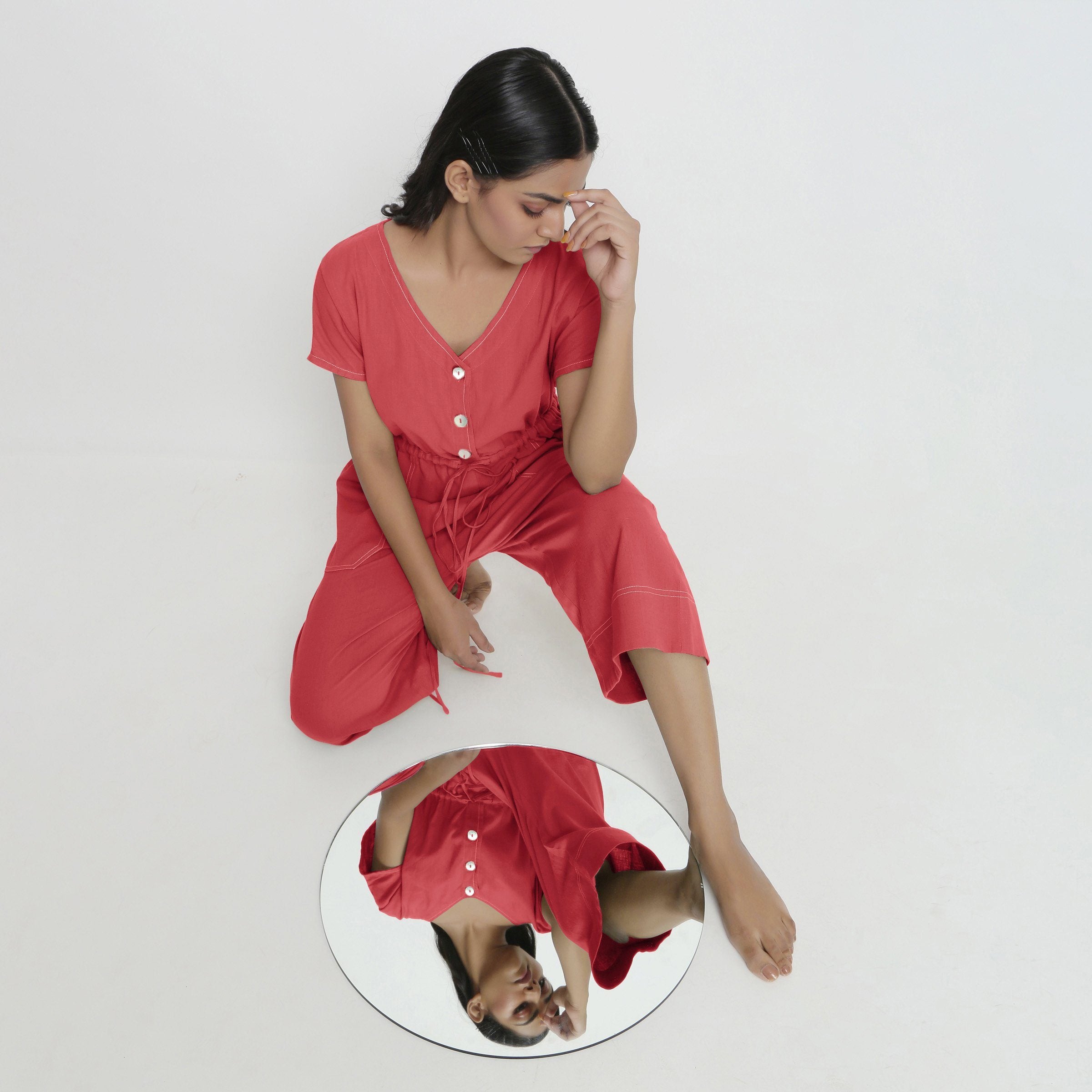 Front View of a Model wearing Brick Red Vegetable Dyed Button-Down Jumpsuit