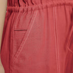 Front Detail of a Model wearing Brick Red Vegetable Dyed Button-Down Jumpsuit