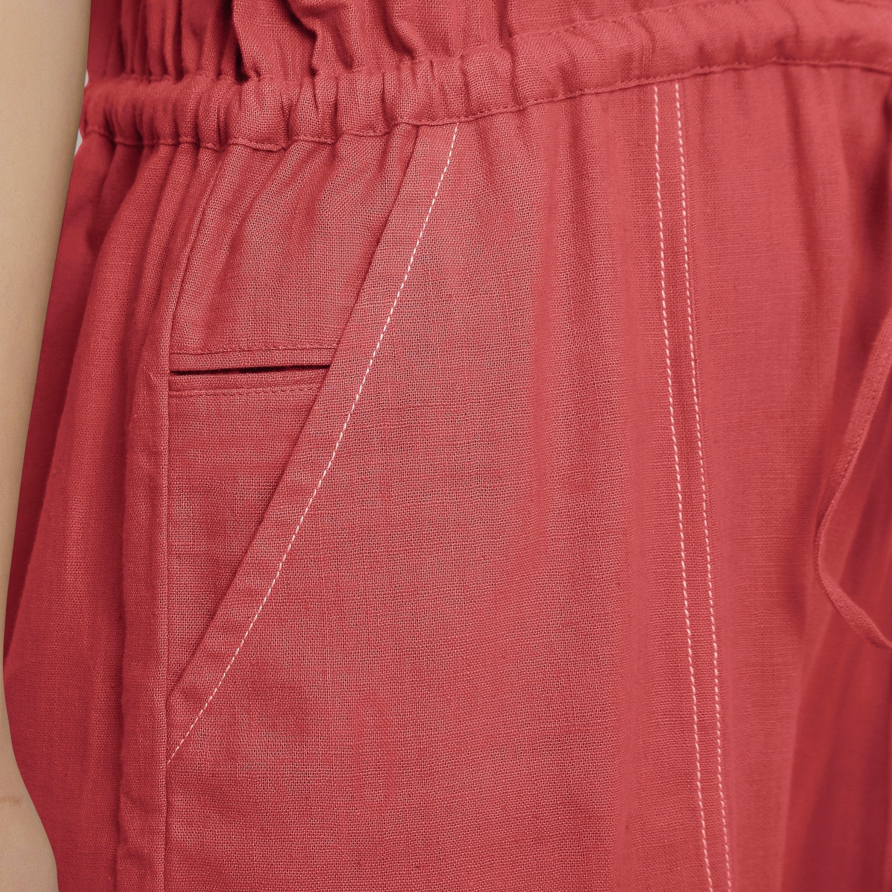 Front Detail of a Model wearing Brick Red Vegetable Dyed Button-Down Jumpsuit