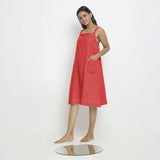Left View of a Model wearing Brick Red Vegetable Dyed Handspun Slip Dress
