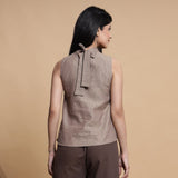 Back View of a Model wearing Brown and Beige Reversible Cotton Yoked Tie-Up Neck Top