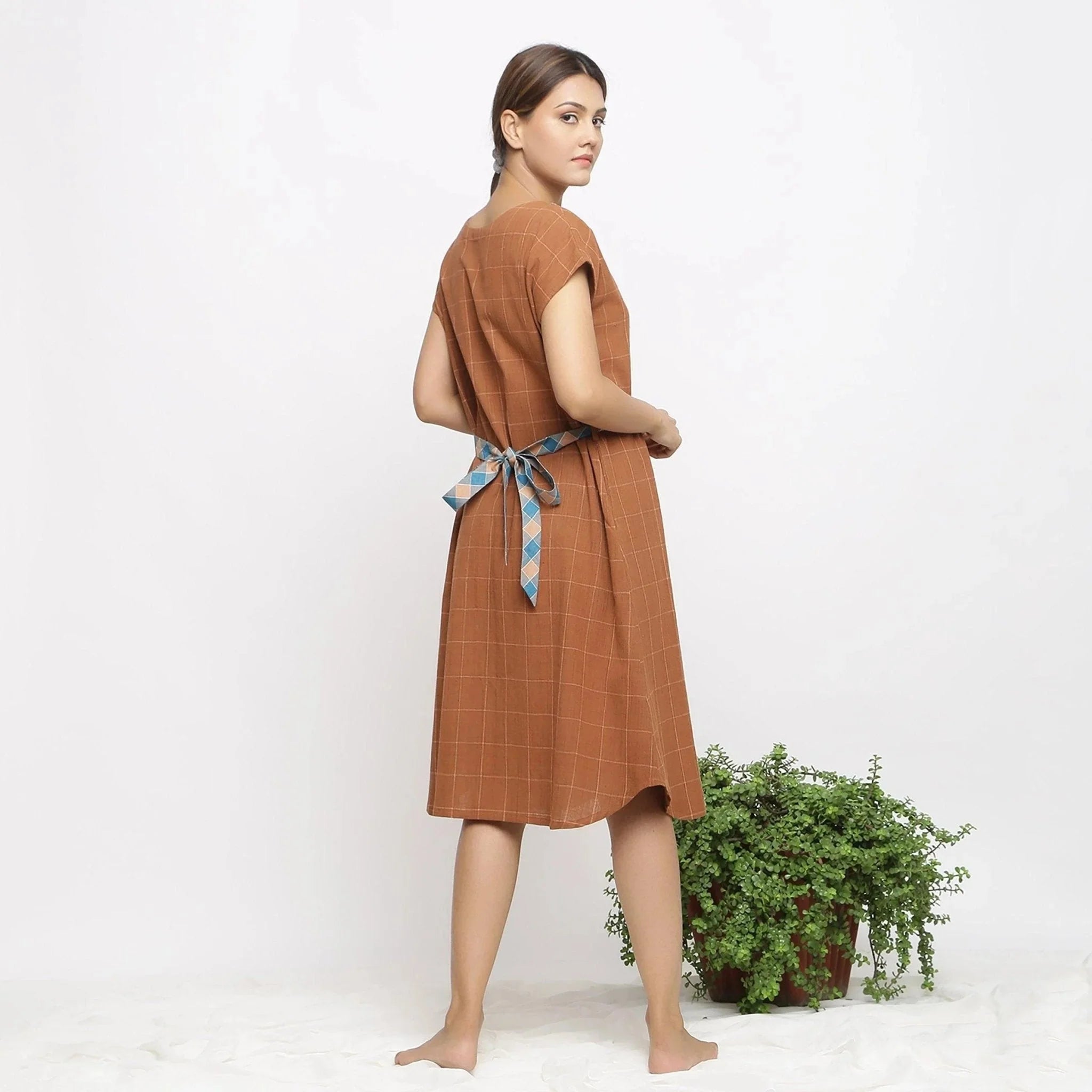 Back View of a Model wearing Brown Handspun V-Neck Shift Dress