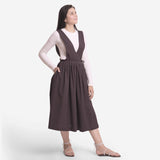 Right View of a Model wearing Brown Deep Neck Pinafore Midi Wrap Dress