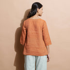 Back View of a Model wearing Brown Handspun Split-Neck Straight Top