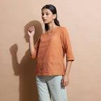 Left View of a Model wearing Brown Handspun Split-Neck Straight Top
