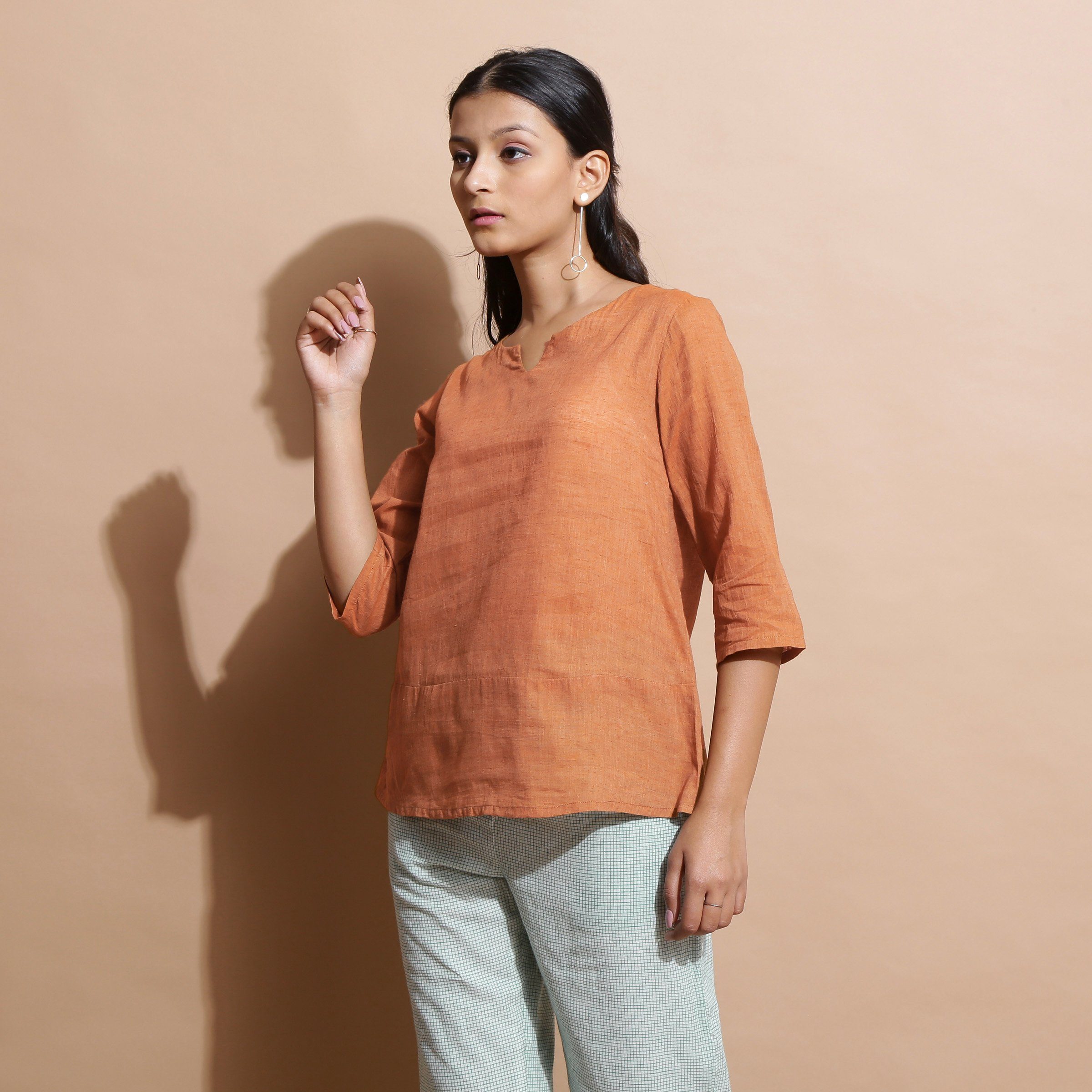 Left View of a Model wearing Brown Handspun Split-Neck Straight Top