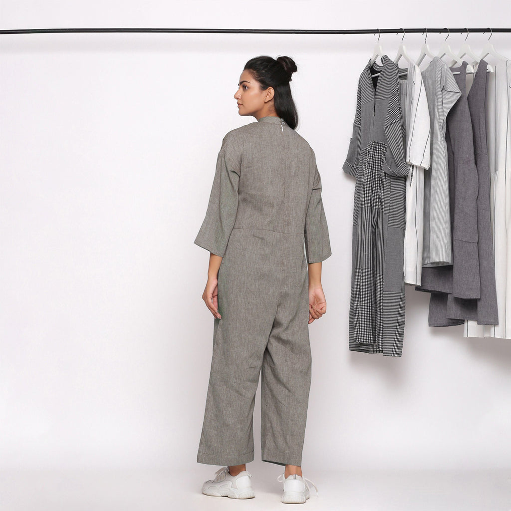Back View of a Model wearing Charcoal Grey Handspun Straight Ankle Length Jumpsuit