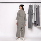 Back View of a Model wearing Charcoal Grey Handspun Straight Ankle Length Jumpsuit