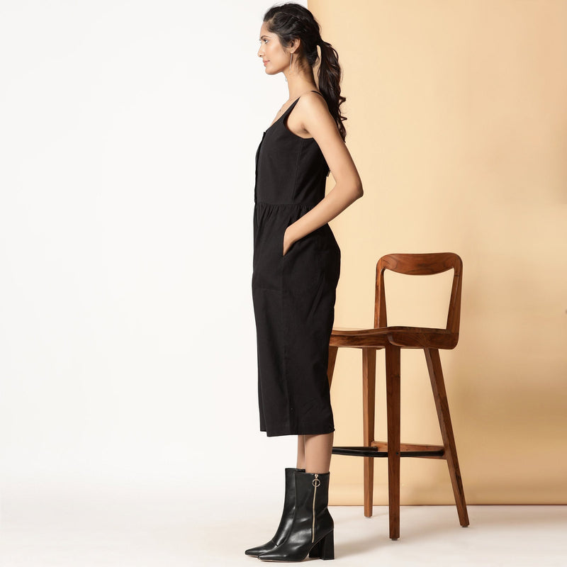 Left View of a Model wearing Chic Black Cotton Button-Down Jumpsuit