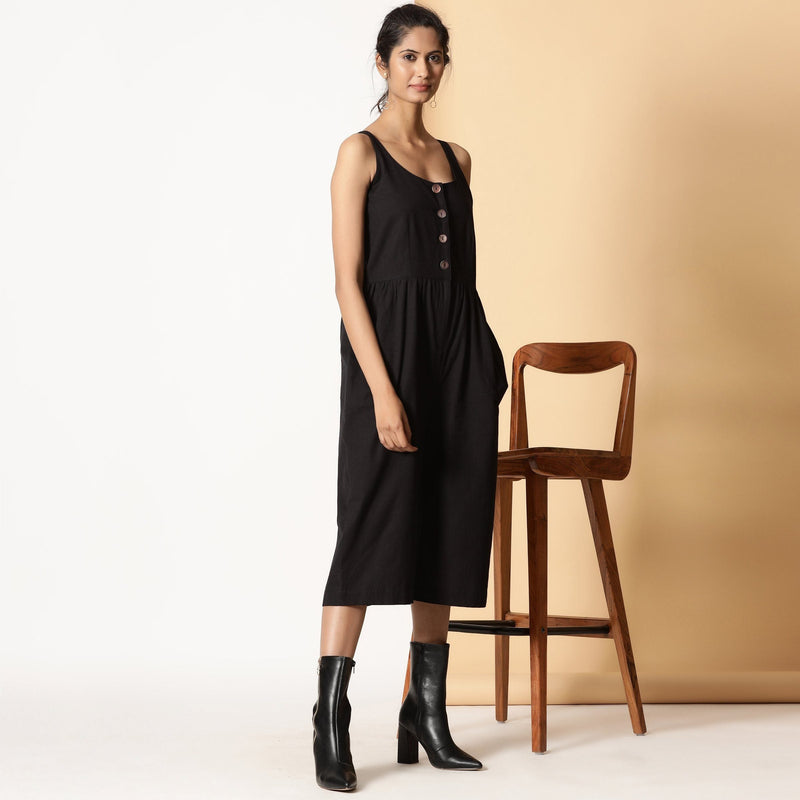Right View of a Model wearing Chic Black Cotton Button-Down Jumpsuit