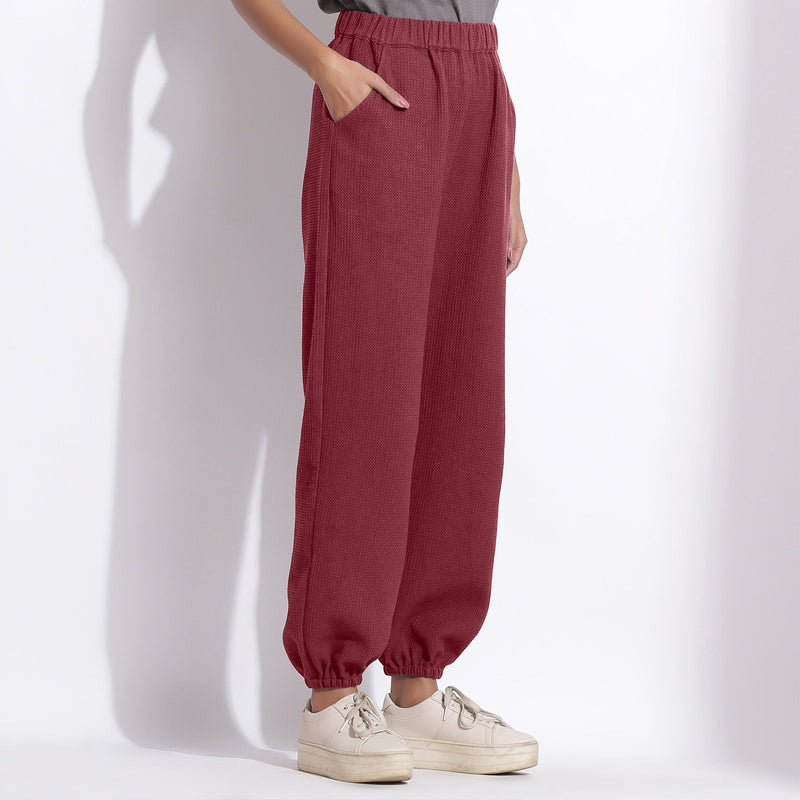Right View of a Model wearing Comfy Barn Red Cotton Waffle Jogger Pants