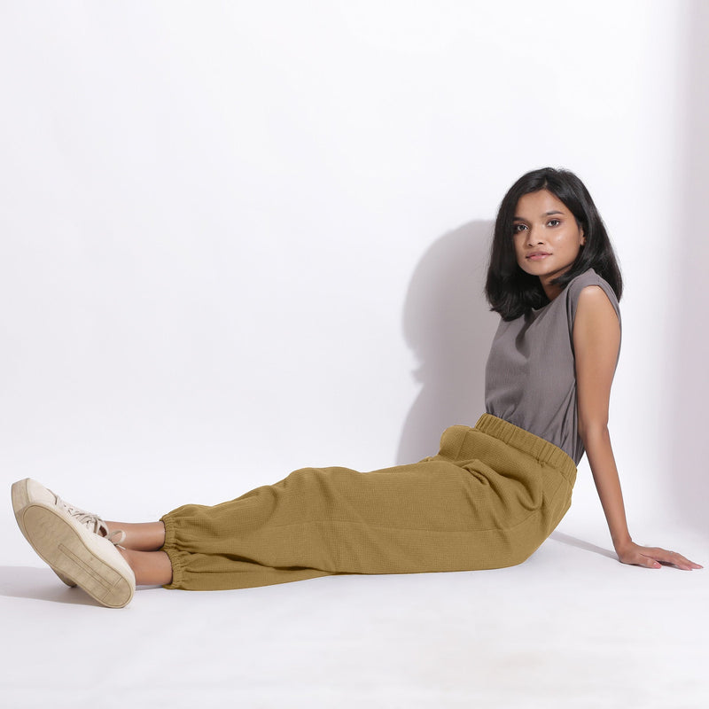 Left View of a Model wearing Comfy Olive Green Cotton Waffle Jogger Pants